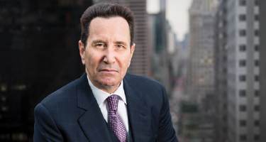 Headshot of attorney with dark brown hair in navy suit
