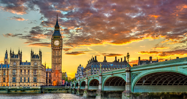 Big Ben and bridge over water in London at sunset