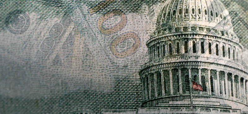 Giant white dome building with image of multiple hundreds of dollars bills overlayed 