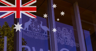 Britain's flag overlayed on the Australia banner hanging from a building 