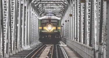 Train approaching on railway tracks.