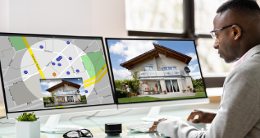 Man looking at houses on computer