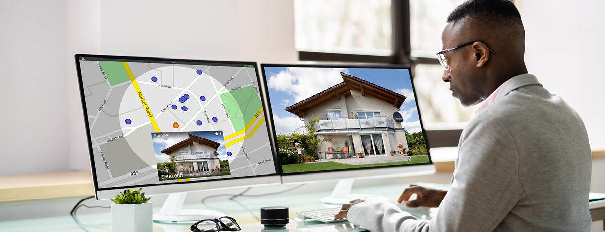 Man looking at houses on computer