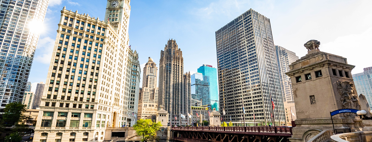 Skyline of Chicago with green river and blue background 