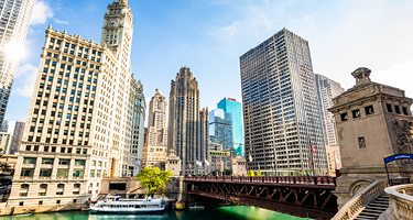 Skyline of Chicago with green river and blue background