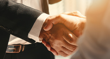 Shaking hands in light 