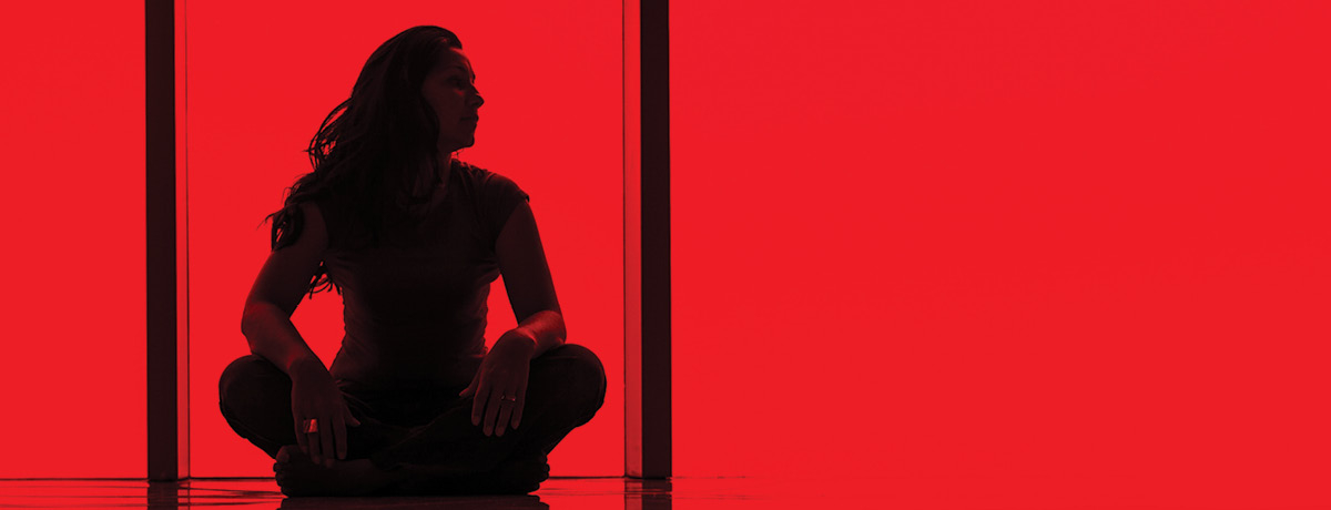 Women sitting on floor in fully red room