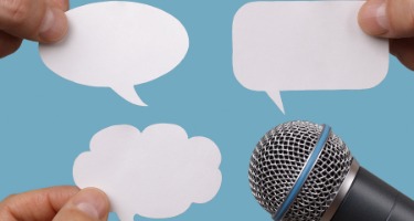 Blue background with microphone with white text bubbles protruding from the tip