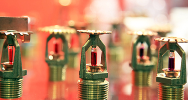 Gold Indoor Sprinkler Heads on Red Background