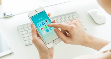 Someone on their phone going to click on social media apps