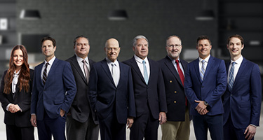 Group Photo of Eight Lawyers at Strong Law Trial Attorneys