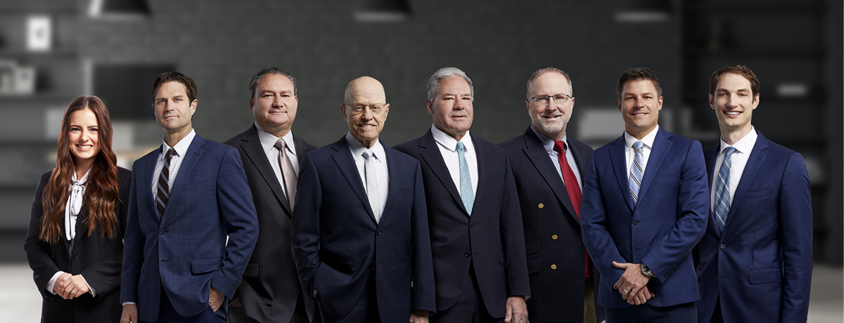 Group Photo of Eight Lawyers at Strong Law Trial Attorneys