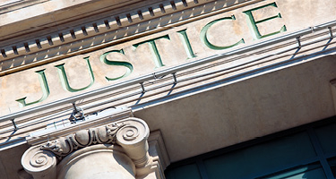 Close up view of courthouse building and word Justice