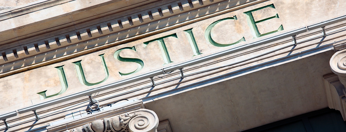 Close up view of courthouse building and word Justice