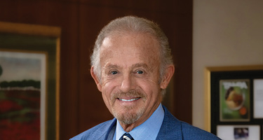 Lawyer in blue suit poses in office for headshot