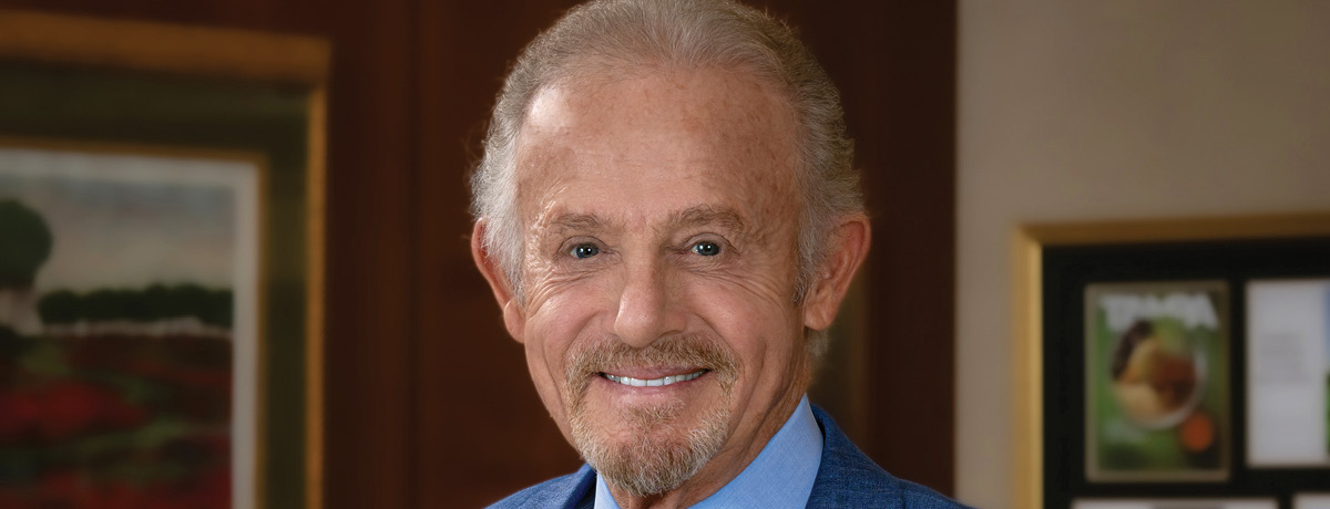 Lawyer in blue suit poses in office for headshot