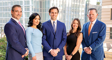 Group of male and female lawyers standing in front of building