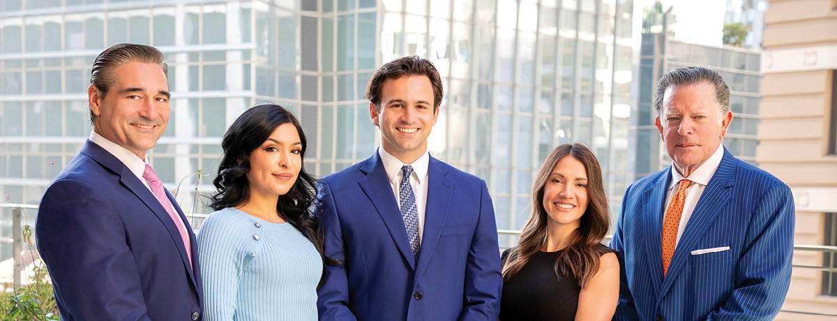 Group of male and female lawyers standing in front of building