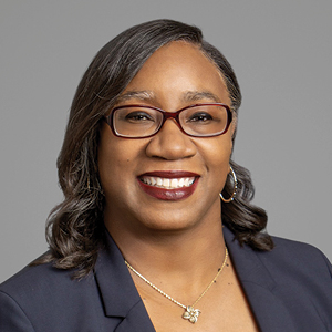 Woman in suit posing for headshot photo