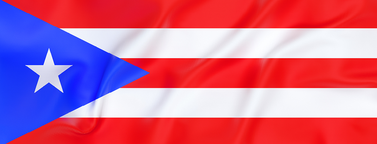 Blue triangle with white star beside red and white stripes