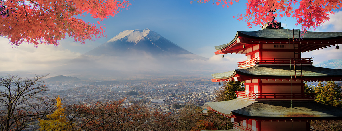 Mt. Fuji in the background with fall leaves and structure in the front