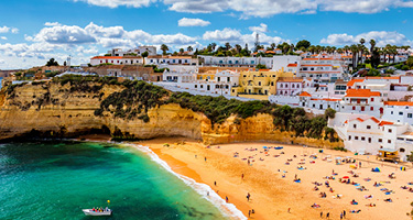 City and beach with green water and blue sky