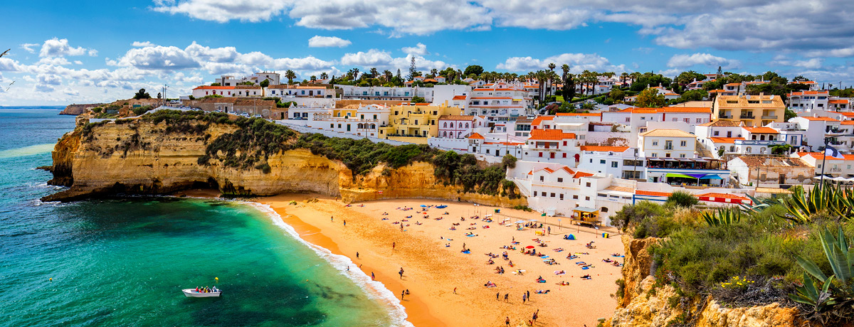City and beach with green water and blue sky