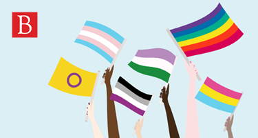 Hands holding pride flags