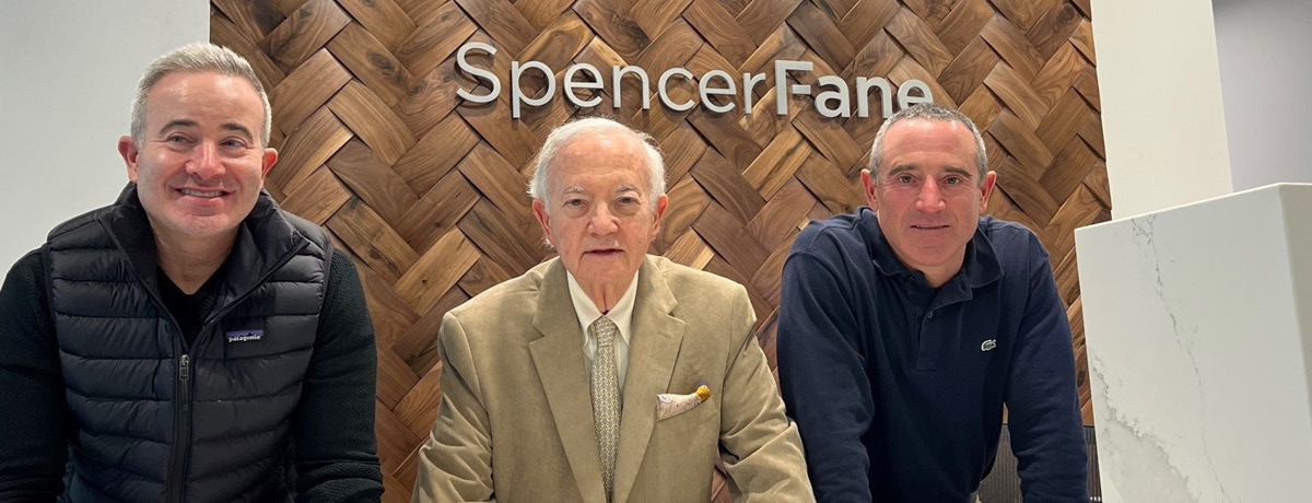 Three Spencer Fane Lawyers in Front of Firm Signage