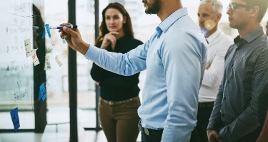 Group of people writing on a board