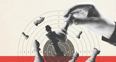 A black and white photo of a hand moving a chess piece over a circular target.