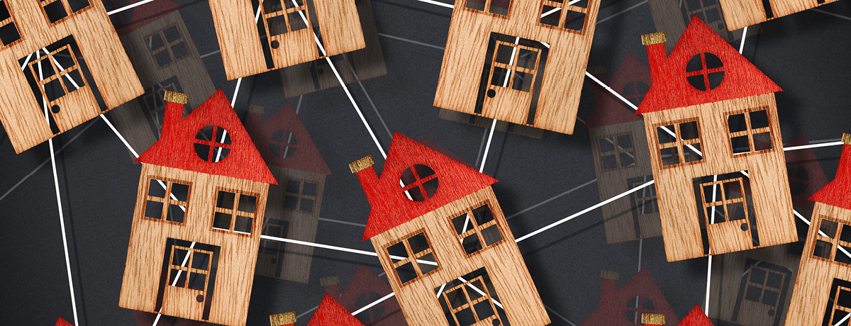 Wooden model houses connected together representing homeowners associations