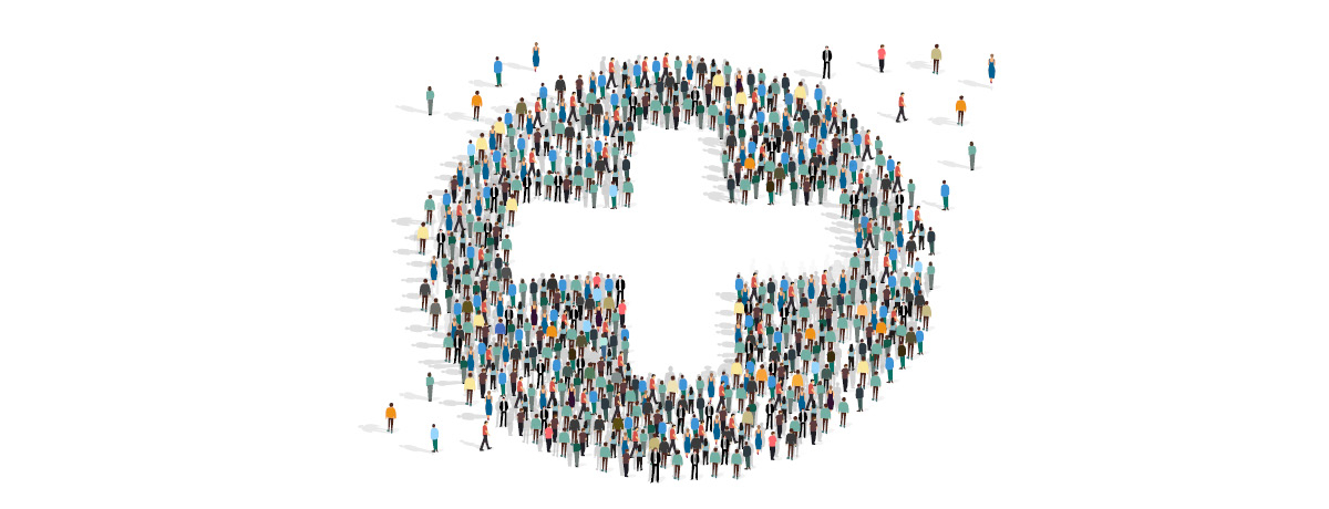 People forming a circle with white cross in center