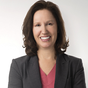 Woman with red shirt and black jacket with brown hair