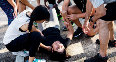 Woman on the floor in visible pain after an injury