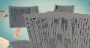 Flying tax documents symbolizing the stress and urgency of mortgage and foreclosure-related paperwor