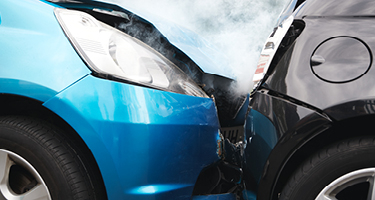 Blue car crashing into black car