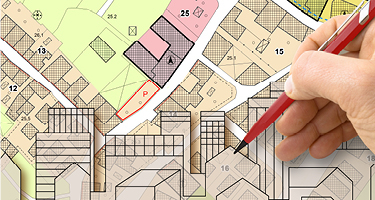 Hand holding pen writing on map