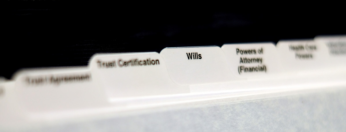 Organized folders labeled “Wills” and “Trusts” representing estate planning documents
