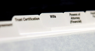 Organized folders labeled “Wills” and “Trusts” representing estate planning documents