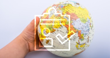 Baby hand with globe and a checklist with a check mark