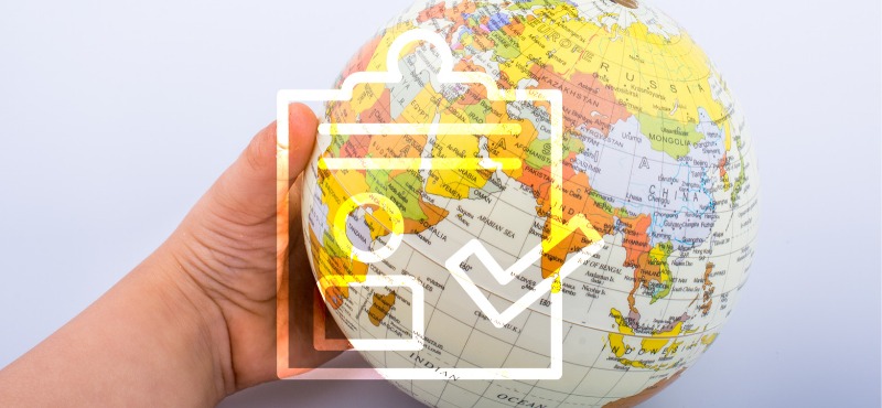 Baby hand with globe and a checklist with a check mark