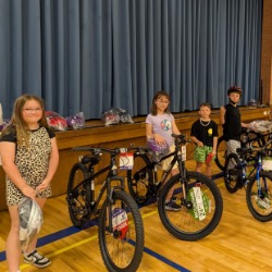 Watkins Calcara Helps Reward Perfect Attendance with New Bikes for USD 428 Students 