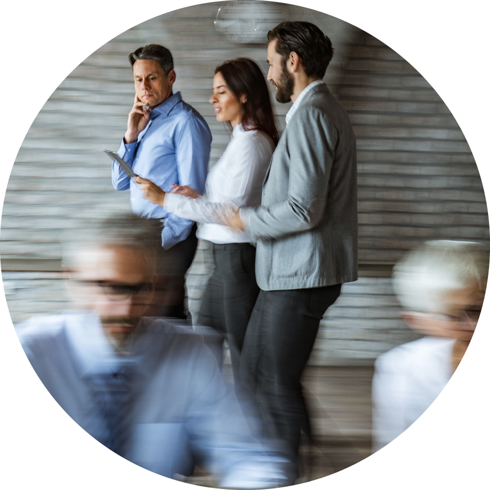 Three colleagues in an office reviewing a document together