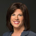 Headshot of female lawyer in grey suit with short brown hair