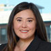 Headshot of female lawyer in dark suit with long dark hair
