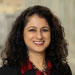 Headshot of female lawyer with dark curly hair